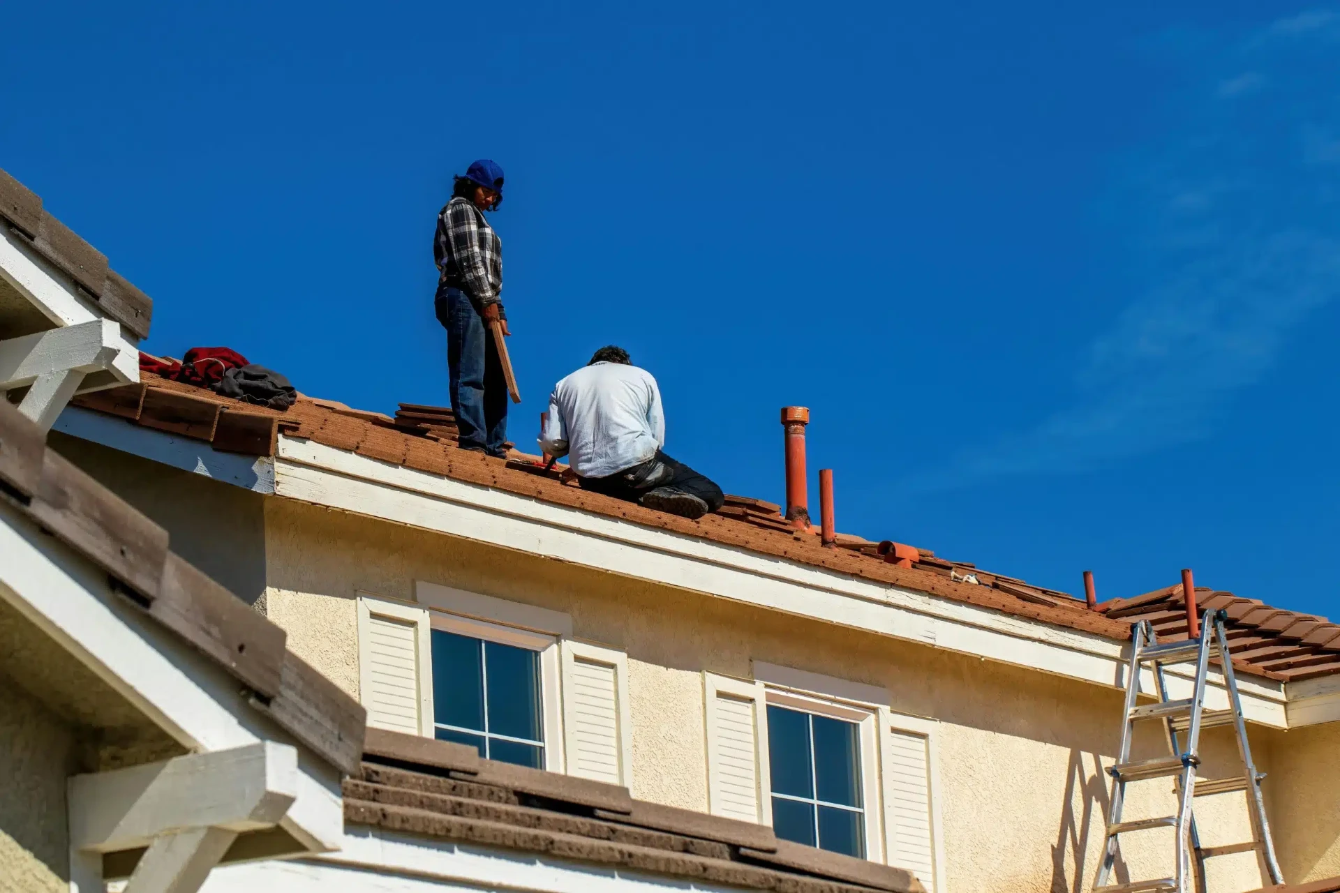 Roofers installing new roof tiles